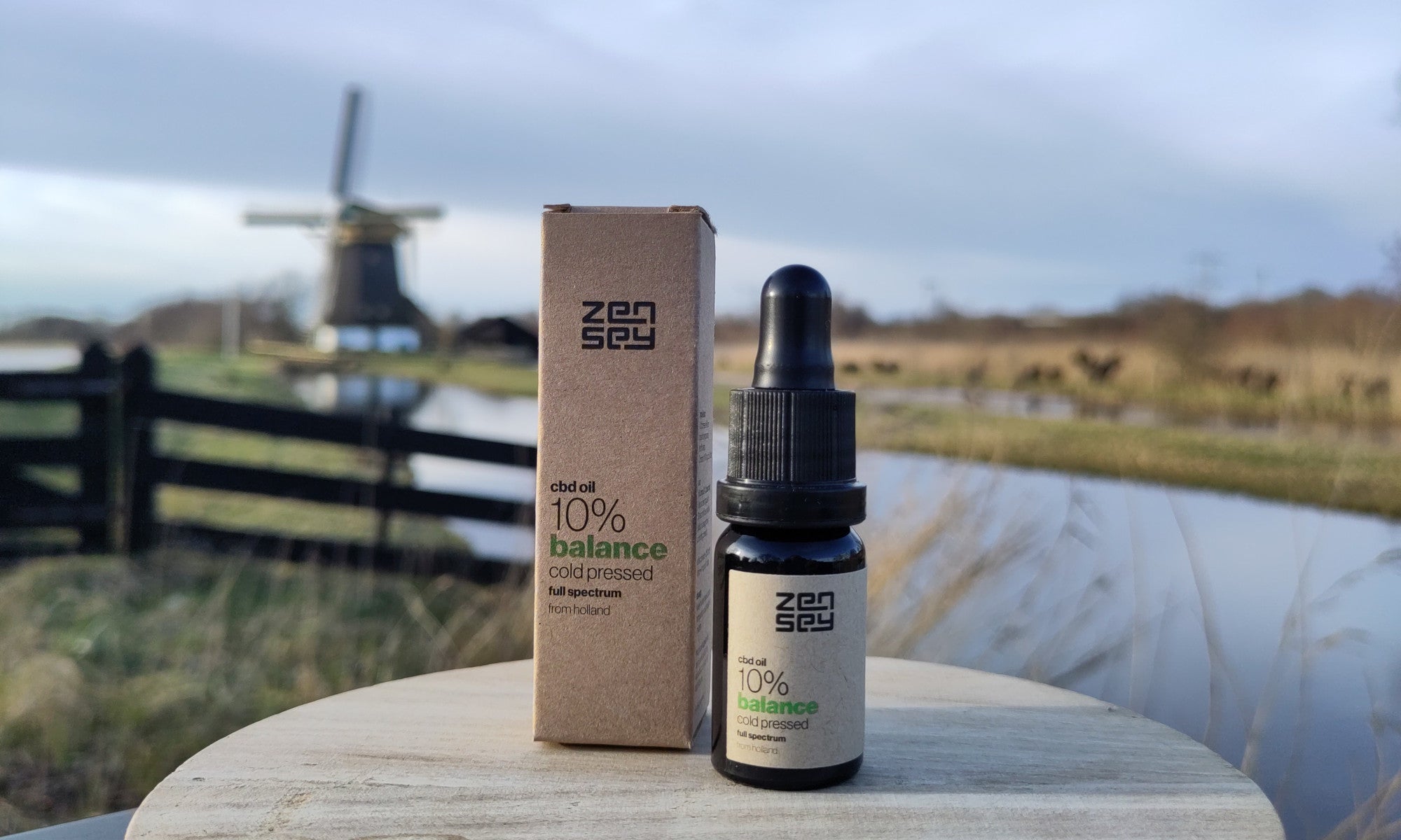 Zensey holland landscape background with cbd bottle